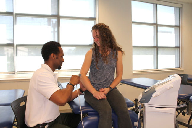 physical therapy students practice with equipment