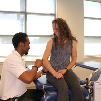Physical therapy student with patient