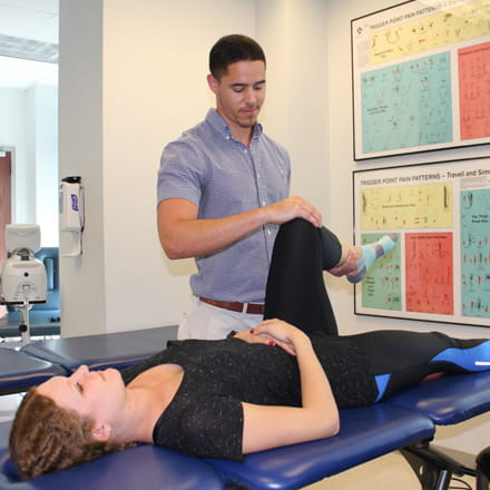 Physical therapy student with patient.