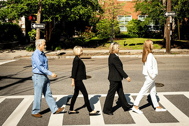Four PT faculty members walking across the crosswalk like the Abbey Road cover.