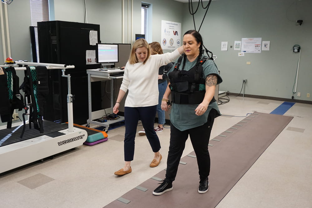 woman walking in harness for stroke recovery research