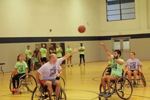 Participants play wheelchair basketball at the Shots with a Spin tournament.