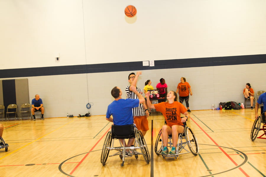 Participants play wheelchair basketball at the Shots with a Spin tournament.