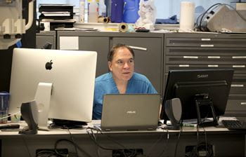 Joe Sistino sits behind a computer to runs simulations for cardiovascular perfusion students.