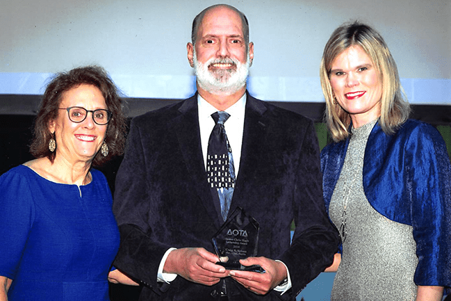 Dr. Craig Velozo accepted his award at the 2019 AOTA Annual Conference. Pictured with (left to right) Ellen Cohn, ScD, OTR/L, FAOTA, 2018 award winner, and AOTA President, Amy Lamb, OTD, OTR/L.