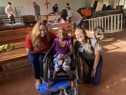 Meghan and student with wheelchair child Uganda