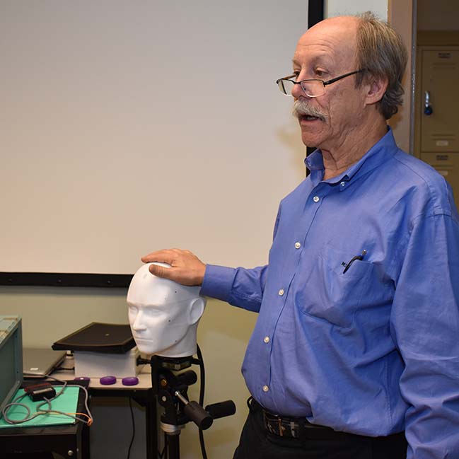 Mark George demonstrates ERIK TMS phantom device during workshop